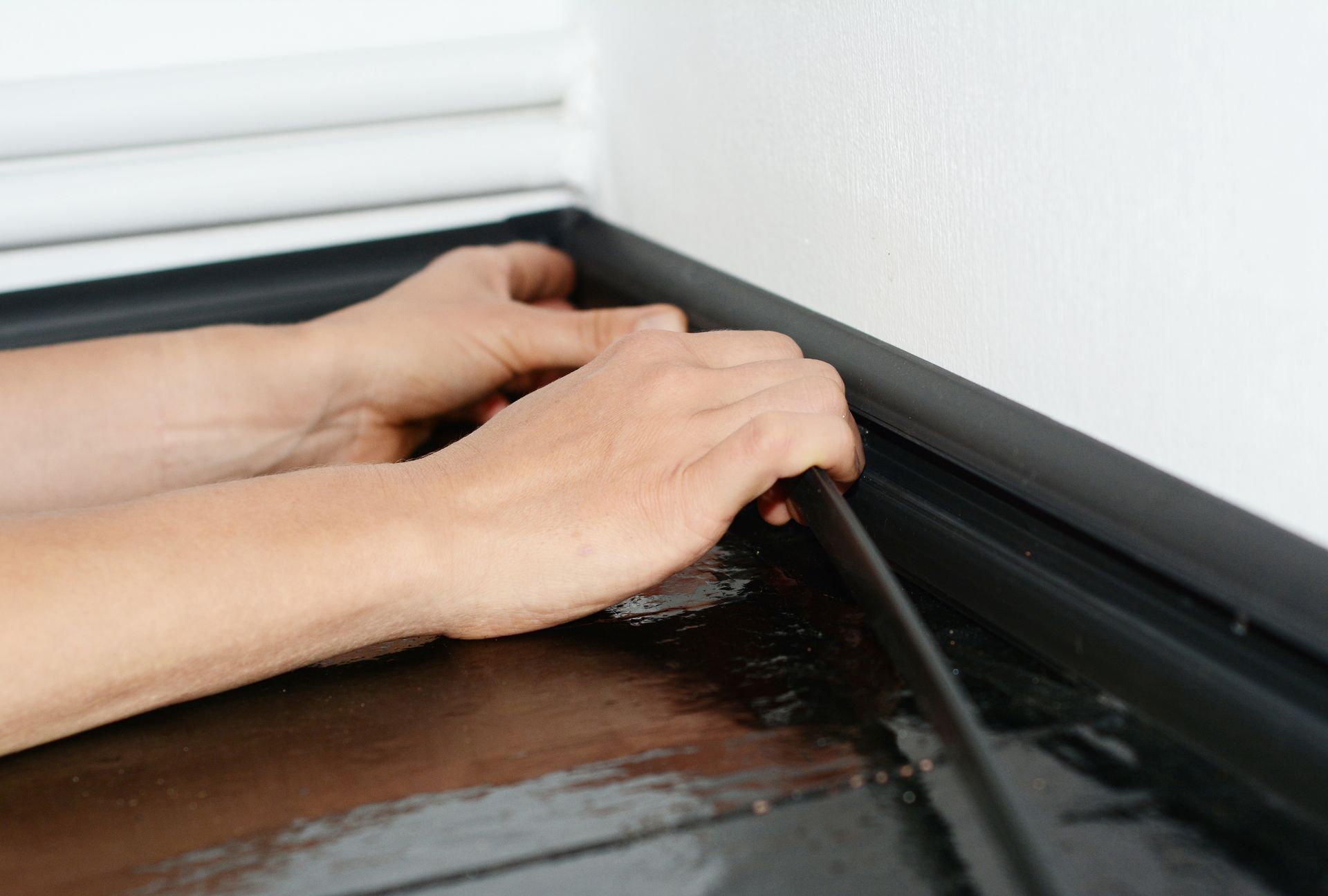A close up of a person 's hands holding a piece of tape.