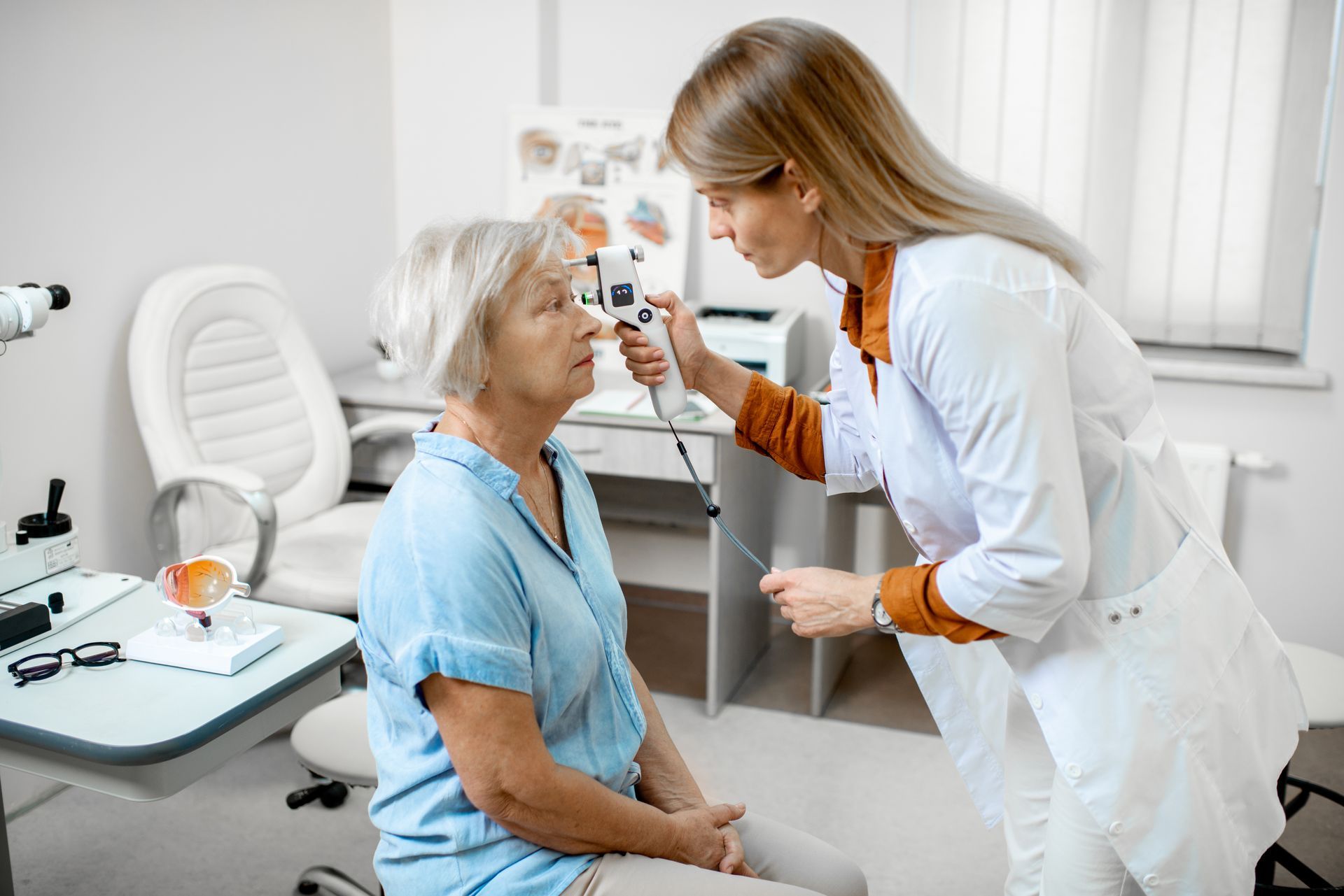 An Eye Care Professional Uses a Handheld Device — Peninsula Eyecare Izzards Optometrists in Kincumber, NSW