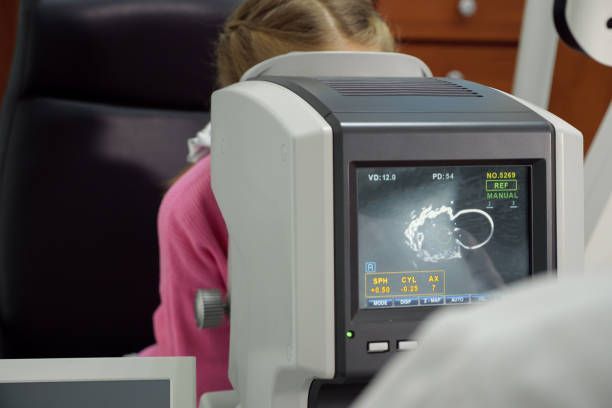 A Person Undergoing an Eye Exam Using an Autorefractor Machine — Peninsula Eyecare Izzards Optometrists in Woy Woy, NSW