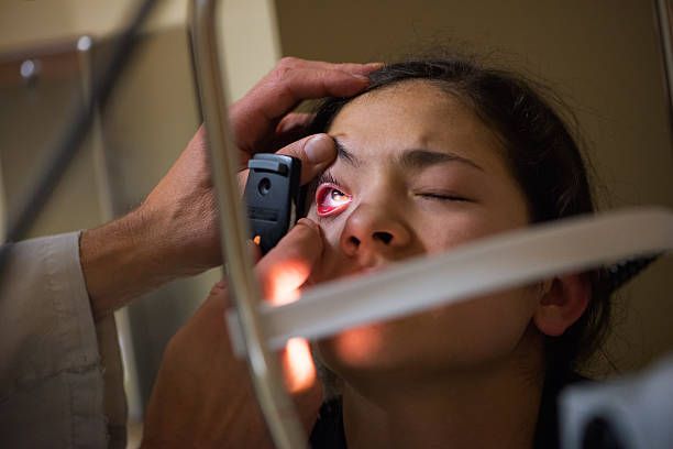 A Medical Professional Examines a Patient's Red, Inflamed Eye — Peninsula Eyecare Izzards Optometrists in Kariong, NSW