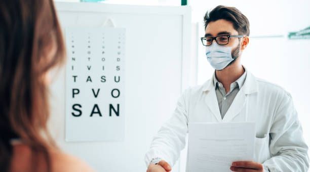 A Doctor Holds a Medical Document — Peninsula Eyecare Izzards Optometrists in Ettalong, NSW