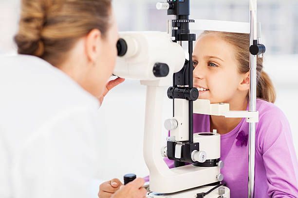 An Eye Doctor Performs a Routine Exam on a Patient Using a Slit Lamp — Peninsula Eyecare Izzards Optometrists in Woy Woy, NSW