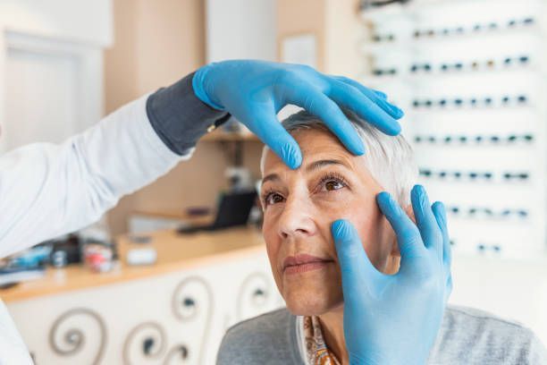 A Healthcare Professional Wearing Blue Gloves — Peninsula Eyecare Izzards Optometrists in Umina Beach, NSW
