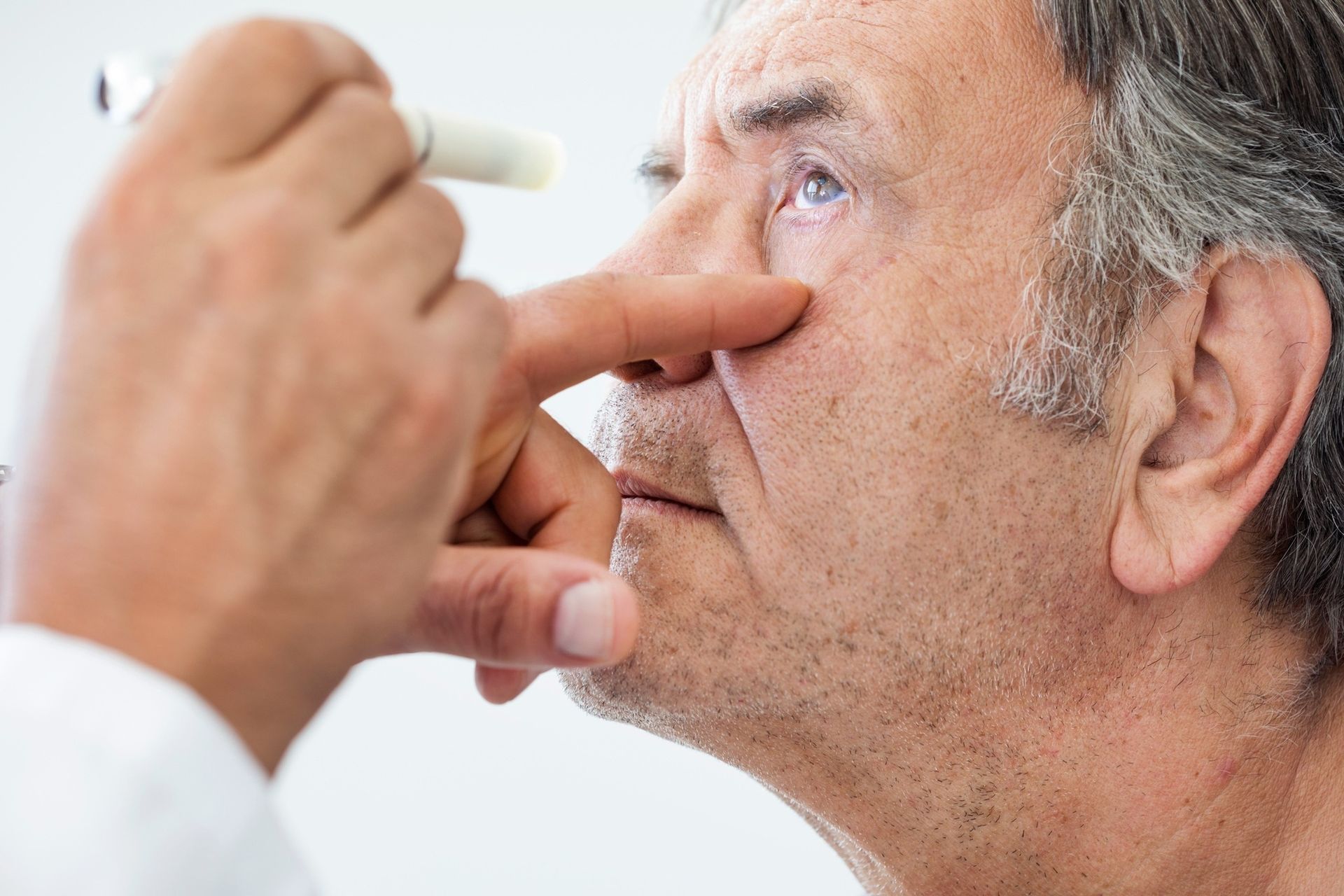 A Healthcare Provider Uses a Penlight to Examine a Patient’s Eye — Peninsula Eyecare Izzards Optometrists in Point Clare, NSW