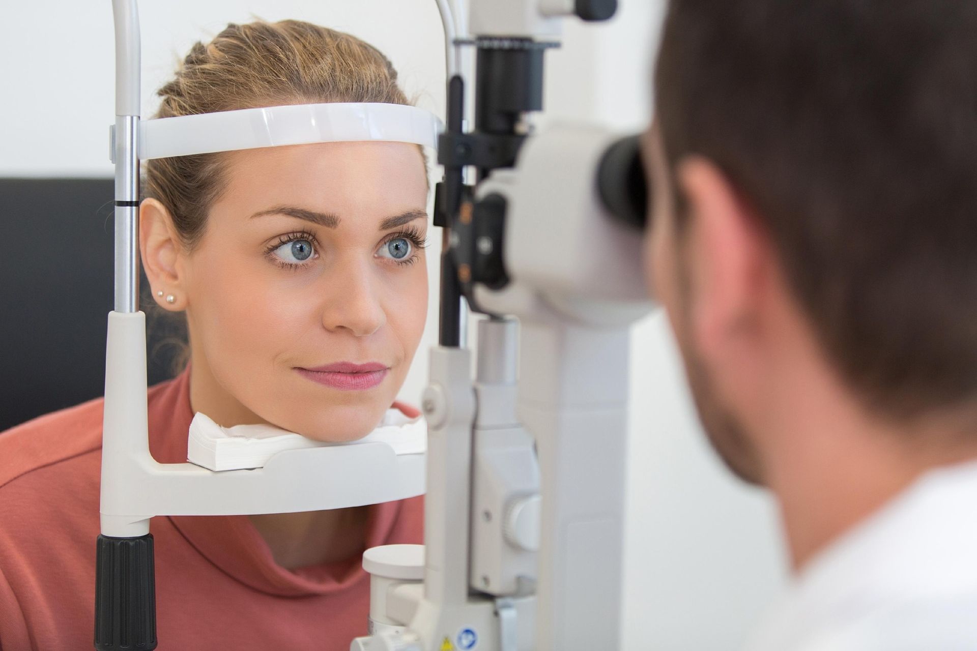 An Eye Doctor Uses a Slit Lamp to Examine a Patient’s Eyes — Peninsula Eyecare Izzards Optometrists in Woy Woy, NSW