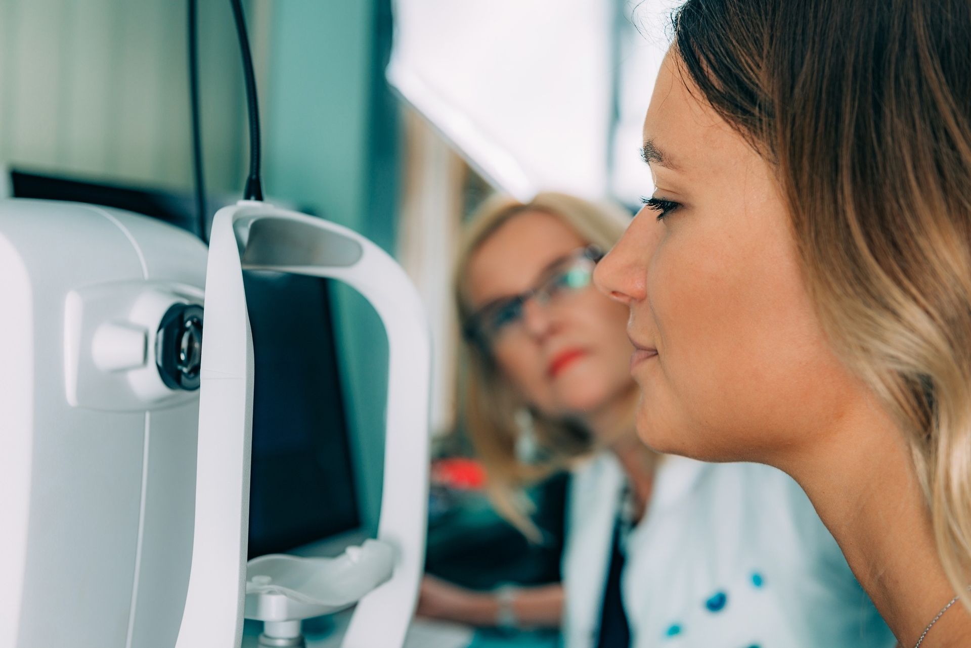 A Patient Looks Into an Eye-examination Machine — Peninsula Eyecare Izzards Optometrists in Ettalong, NSW