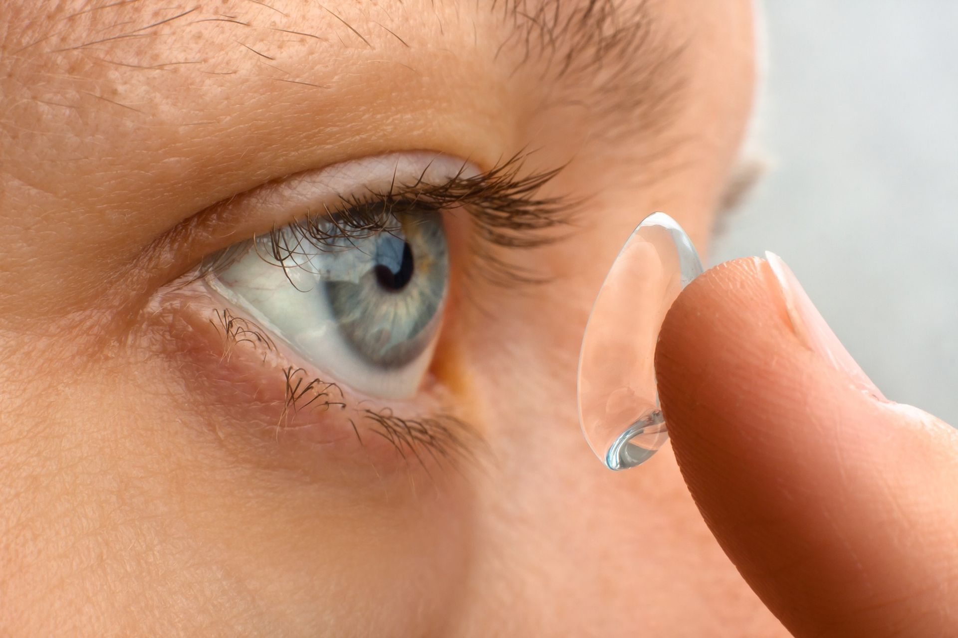 A Person Holding a Clear Contact Lens on Their Fingertip — Peninsula Eyecare Izzards Optometrists in Woy Woy, NSW