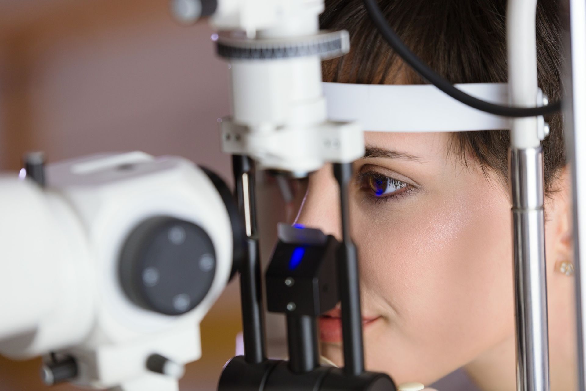 A Person Undergoing an Eye Examination With a Slit Lamp — Peninsula Eyecare Izzards Optometrists in Woy Woy, NSW