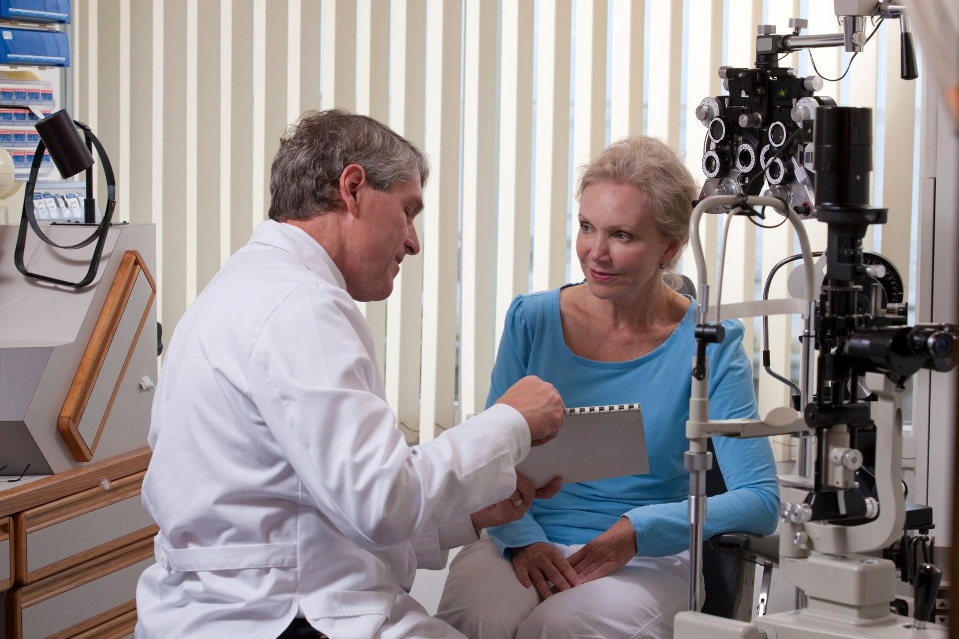 An Eye Doctor in a White Lab Coat Consults — Peninsula Eyecare Izzards Optometrists in Tascott, NSW