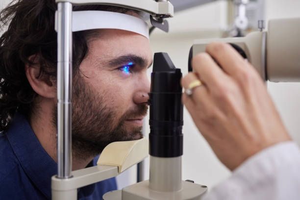 A Person Sits at a Slit Lamp Microscope — Peninsula Eyecare Izzards Optometrists in Woy Woy, NSW