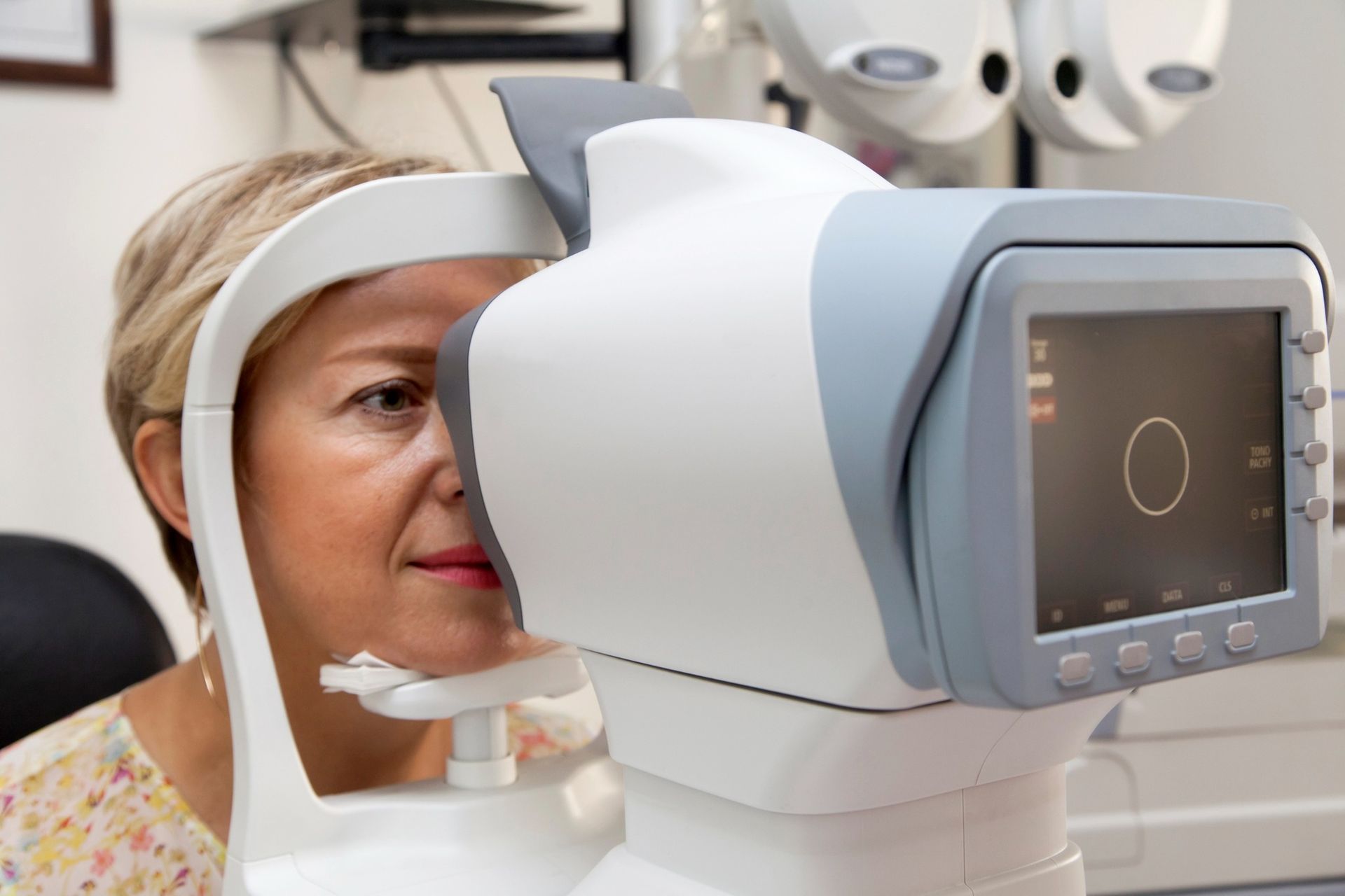 A Person Leaning Their Chin on a Medical Device — Peninsula Eyecare Izzards Optometrists in Umina Beach, NSW