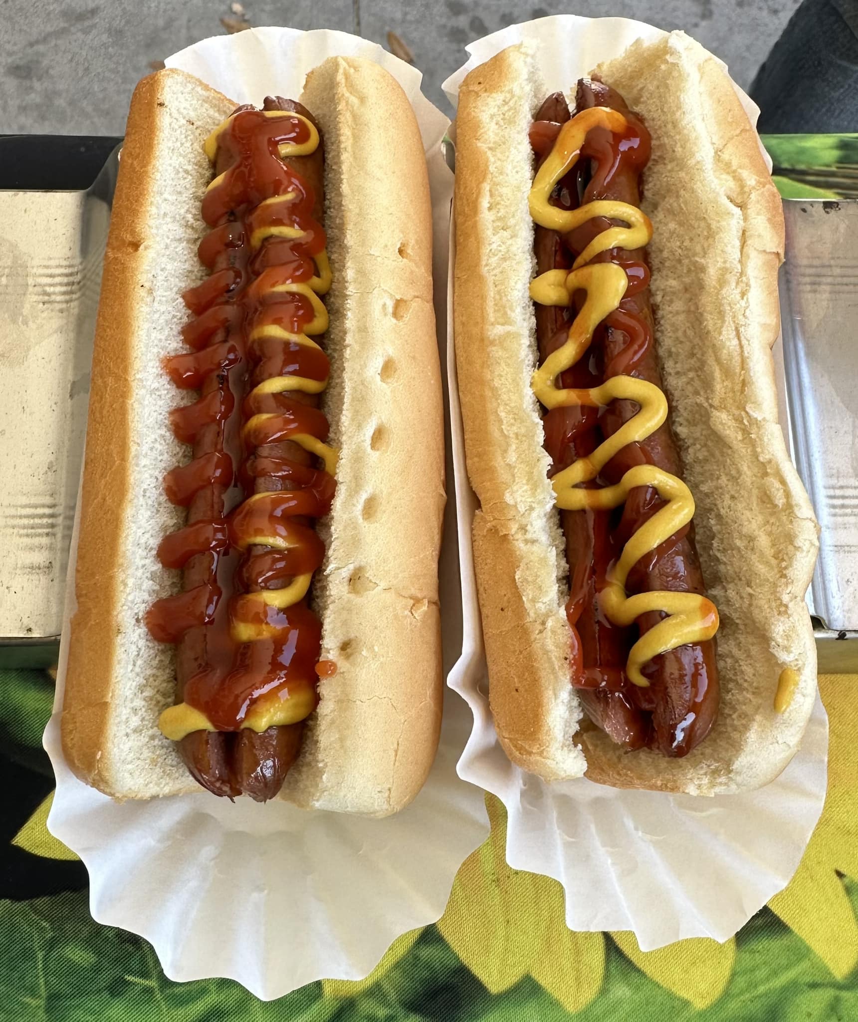 Two Hotdogs Covered With Ketchup And Mustard — Orlando, FL — The Hot Dog Guy Catering