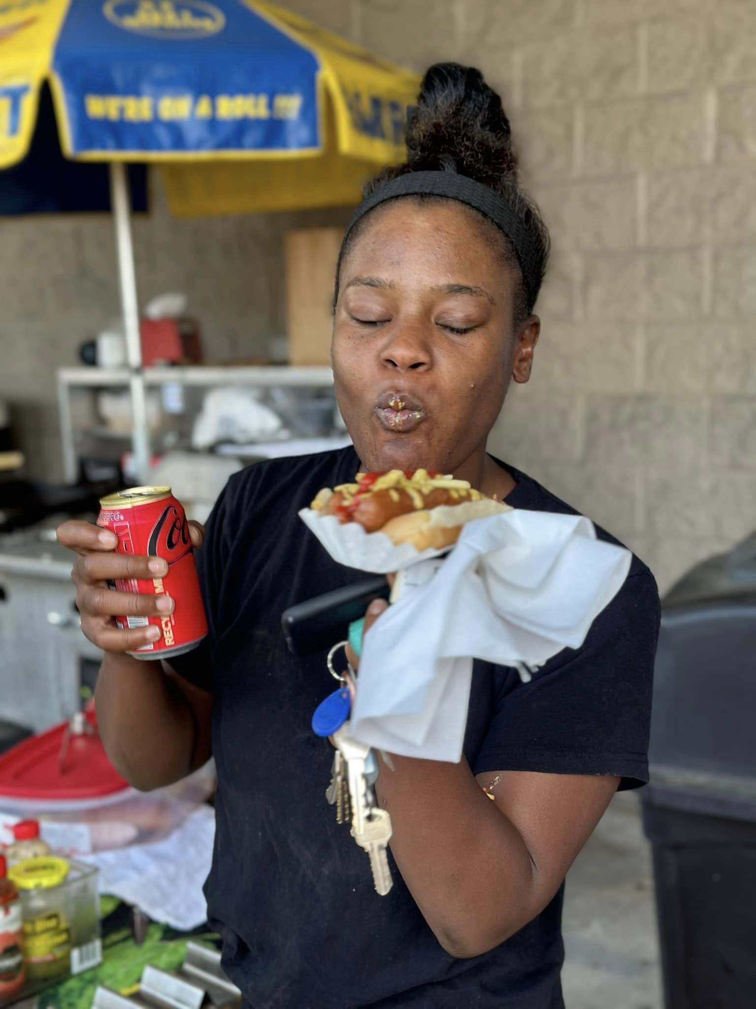 A Woman Eating A Hotdog — Orlando, FL — The Hot Dog Guy Catering