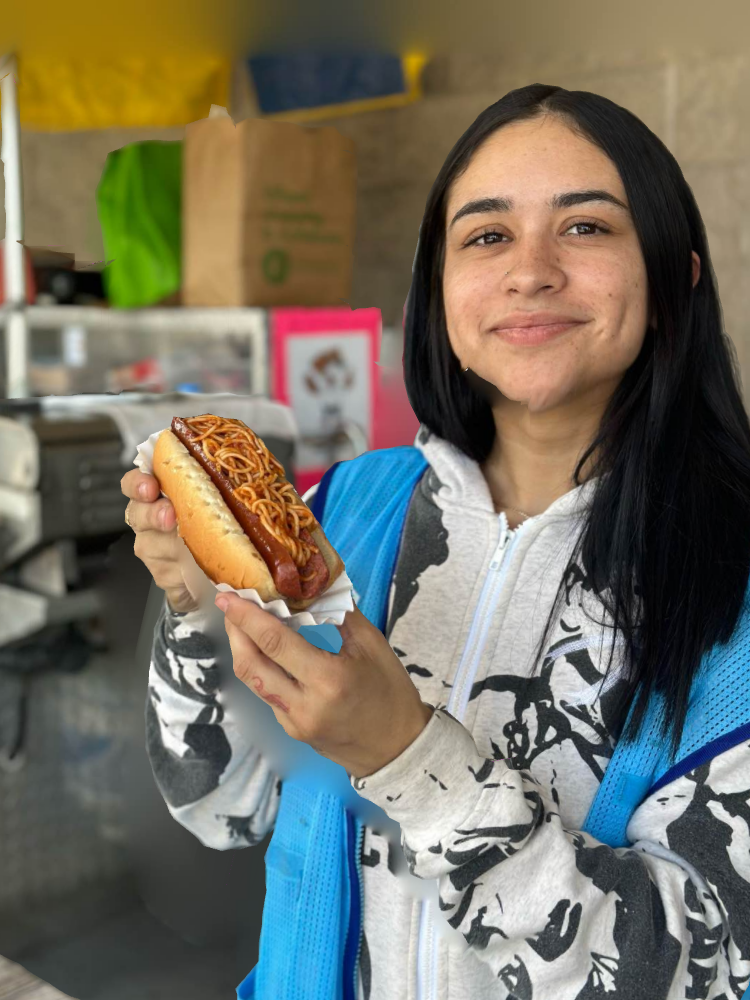 A Young Lady Holding A Hotdog In A Bun — Orlando, FL — The Hot Dog Guy Catering