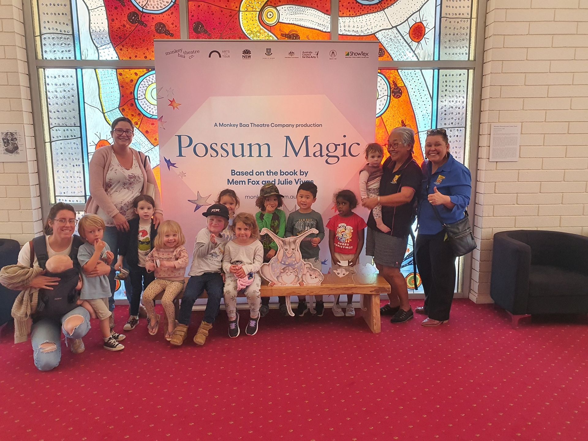 Group of children and adults posing with a 