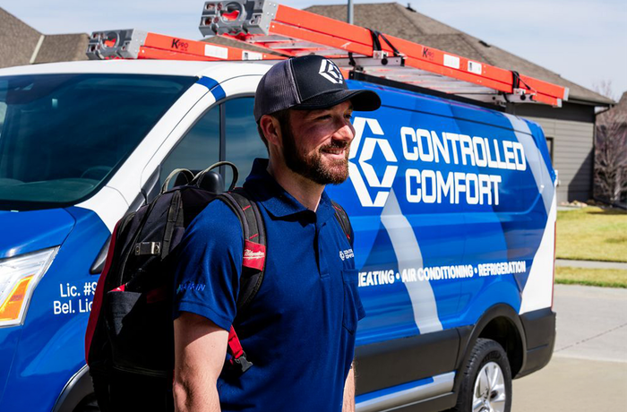Controlled Comfort technician beside a branded service van