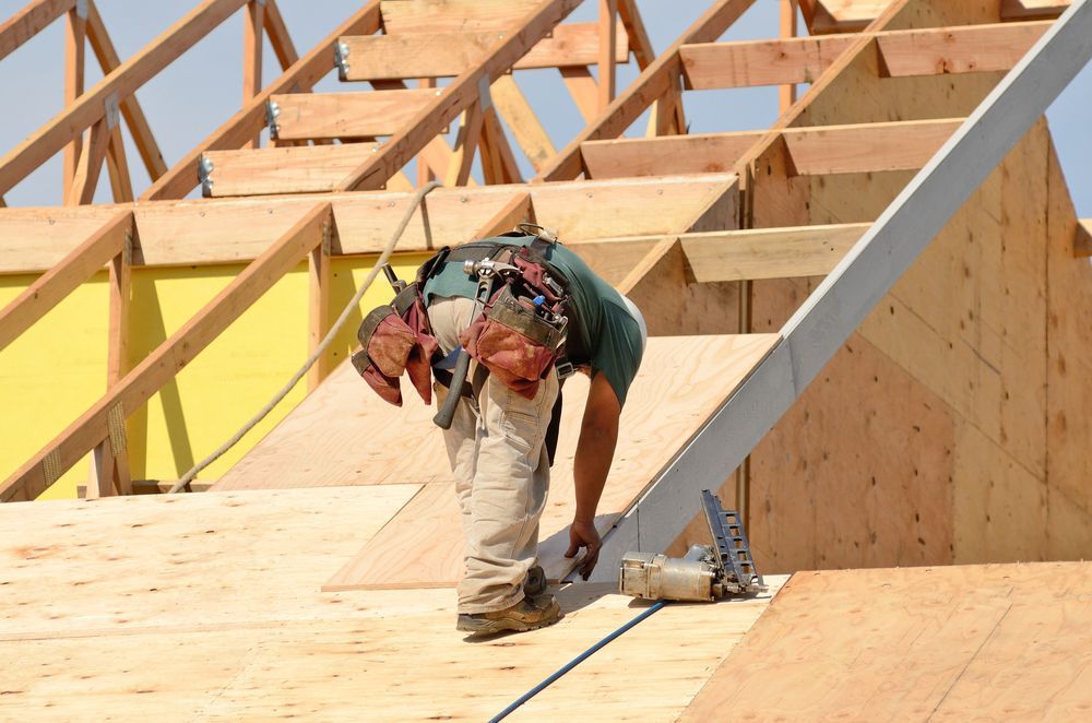 Construction Worker on a Roof Wearing a Safety Harness — Wilko Plate (Aust) Pty Ltd in Tully, QLD