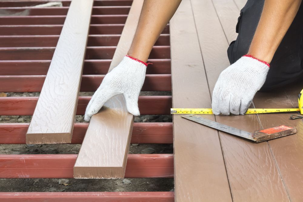 Person Measuring and Positioning Deck Boards — Wilko Plate (Aust) Pty Ltd in Charters Towers, QLD