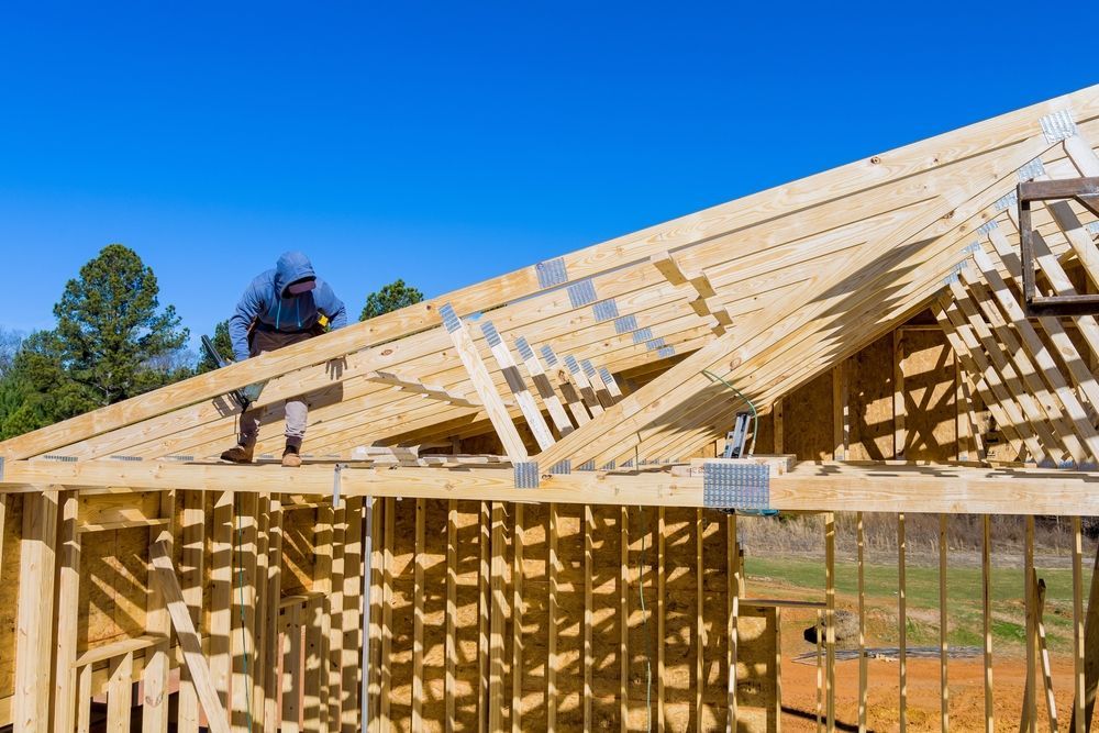 Construction Worker Installing Roof Trusses — Wilko Plate (Aust) Pty Ltd in Atherton, QLD