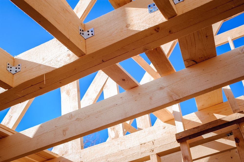 Wooden Beams of a Roof Frame Under a Bright Blue Sky — Wilko Plate (Aust) Pty Ltd in Atherton, QLD