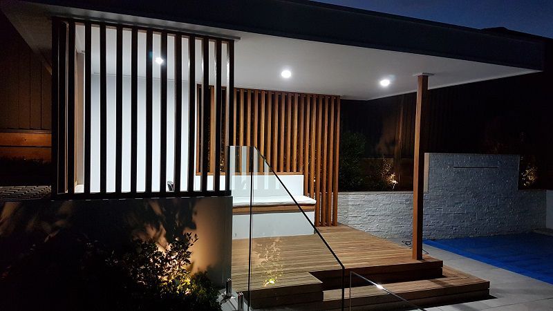 A Fence Surrounding a Swimming Pool With a House in the Background — Gunter Electrical In Kariong, NSW