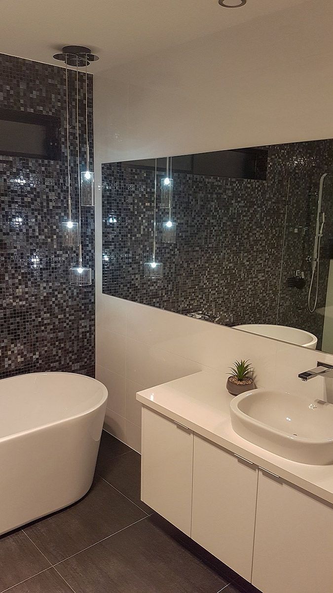 A Bathroom With a Bathtub, Sink and Mirror — Gunter Electrical In Kariong, NSW