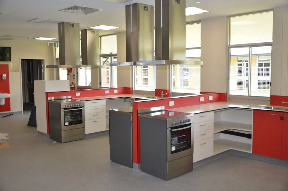 A Large Room With a Lot of Boxes on the Floor and a Ladder — Designer Kitchens in Berrimah, NT