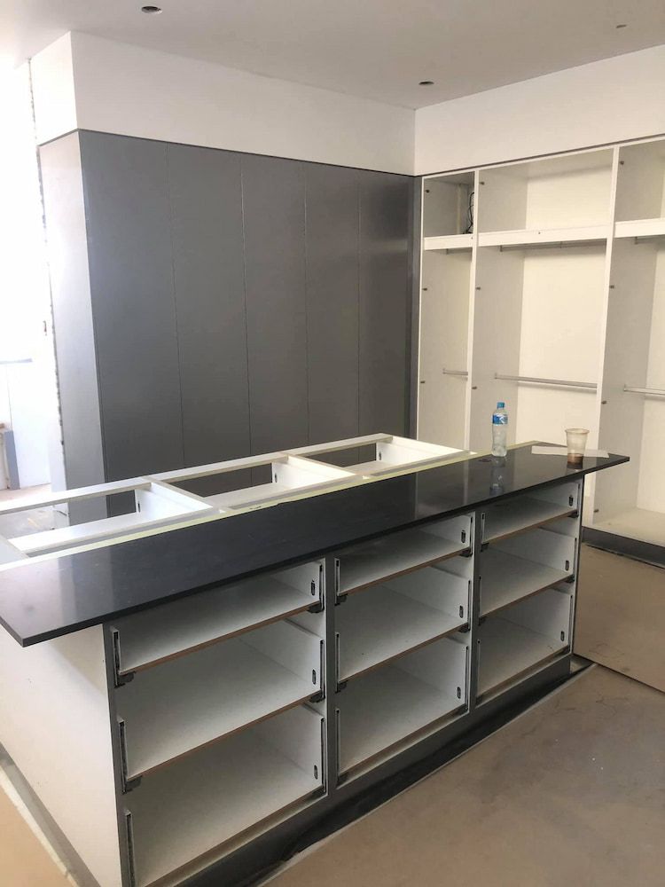 A Room With a Lot of Cabinets and Shelves — Designer Kitchens in Berrimah, NT