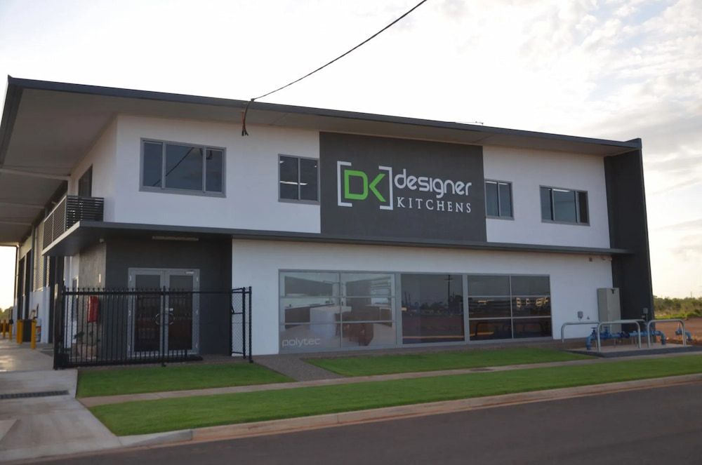 A Large White Building With a Sign That Says Designer Kitchens — Designer Kitchens in Berrimah, NT
