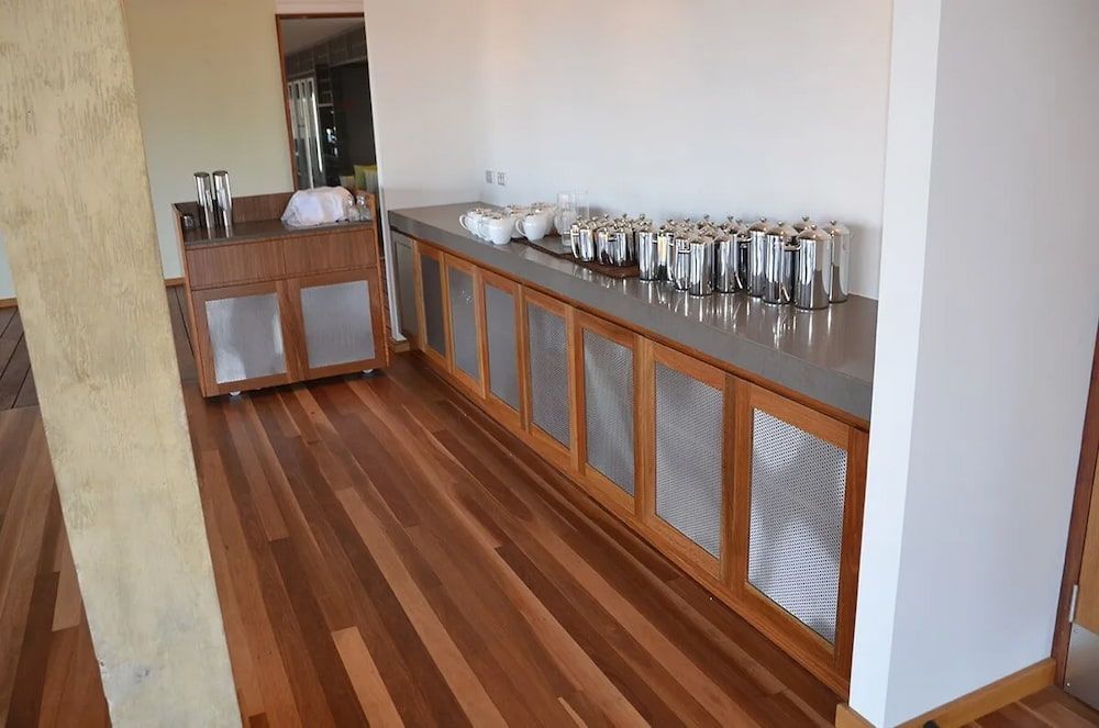 A Buffet Line in a Room With Wooden Floors — Designer Kitchens in Berrimah, NT