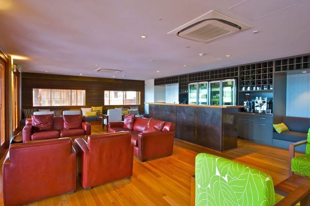 A Living Room Filled With Furniture and a Bar — Designer Kitchens in Berrimah, NT