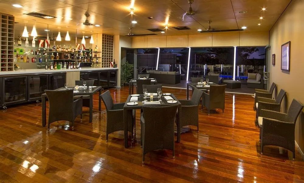 A Restaurant With Tables and Chairs and a Bar — Designer Kitchens in Berrimah, NT