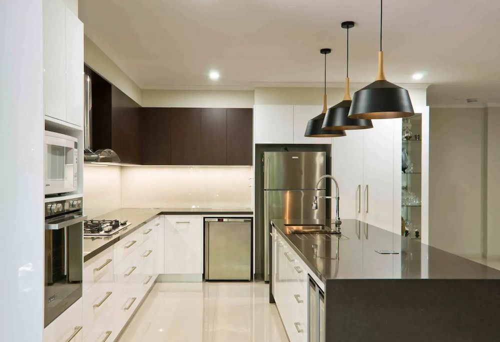 A kitchen with stainless steel appliances and white cabinets — Designer Kitchens in Berrimah, NT