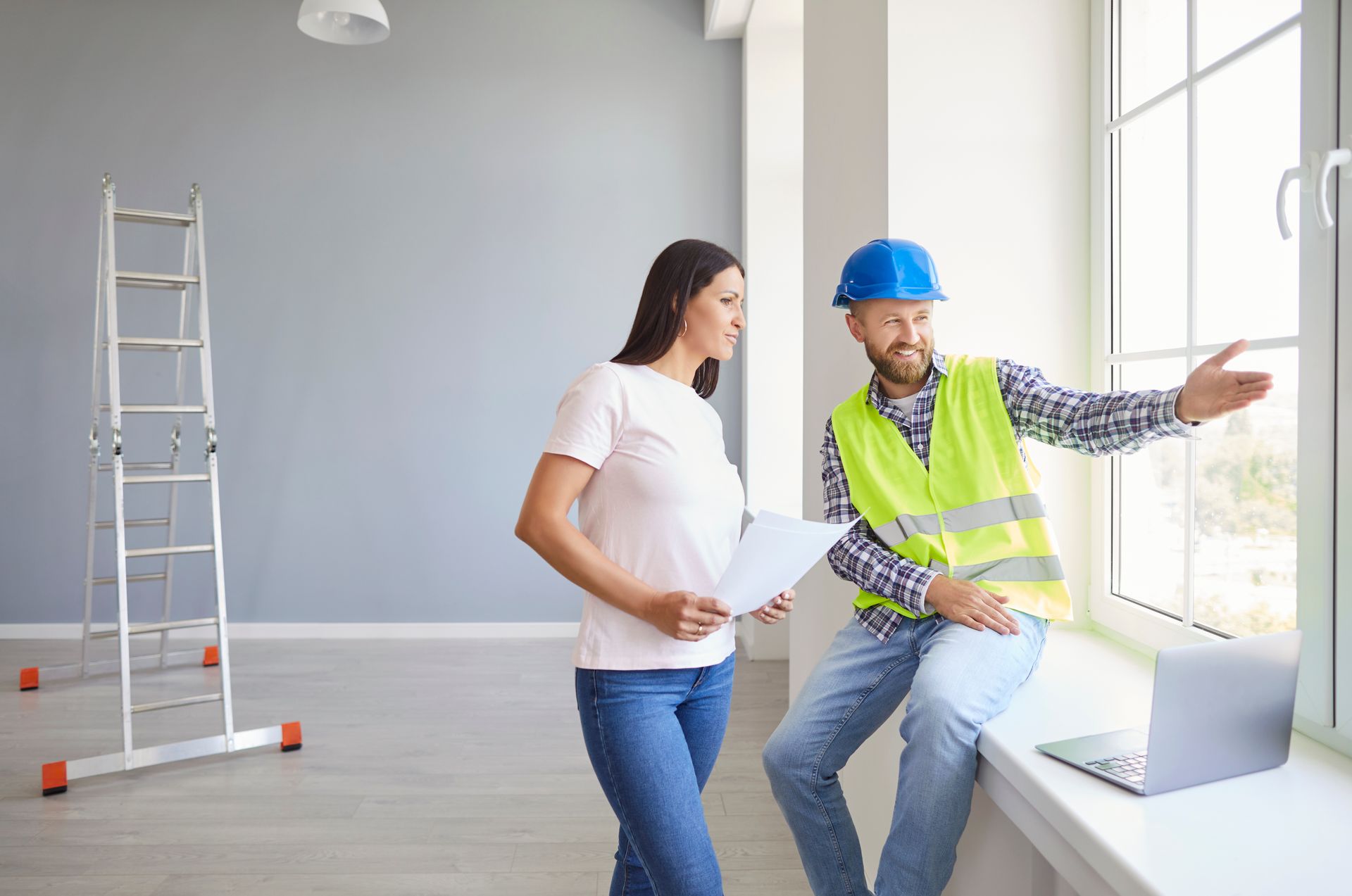 Window estimate consultation with a contractor and homeowner indoors