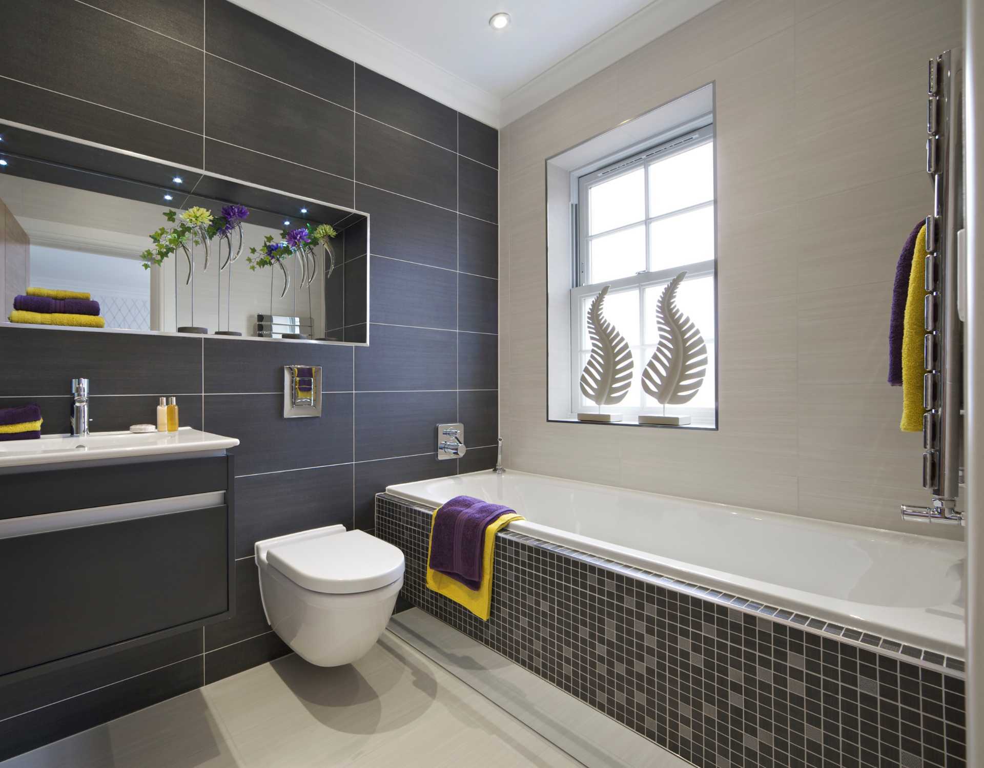 A bathroom with a toilet a sink and a bathtub