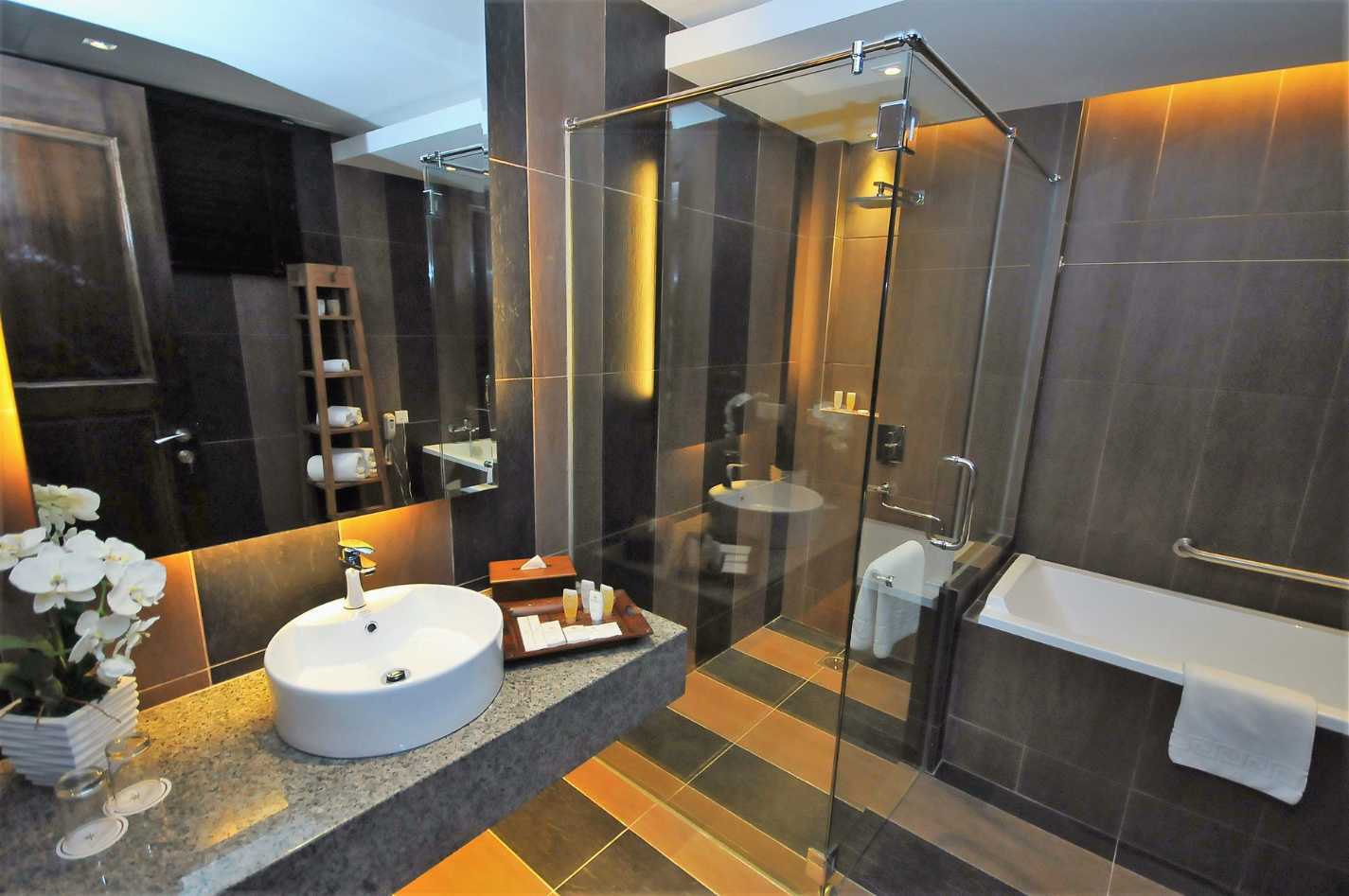 A bathroom with a sink and a walk in shower