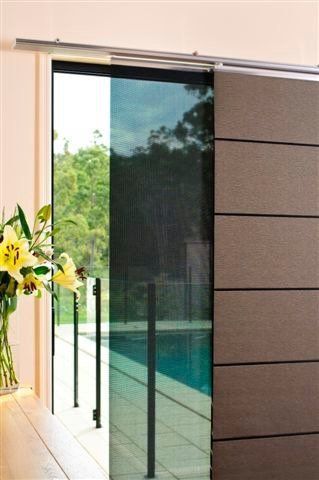 Door to pool area partially blocked by panel glide blind — Blind Outfitters in Atherton, QLD