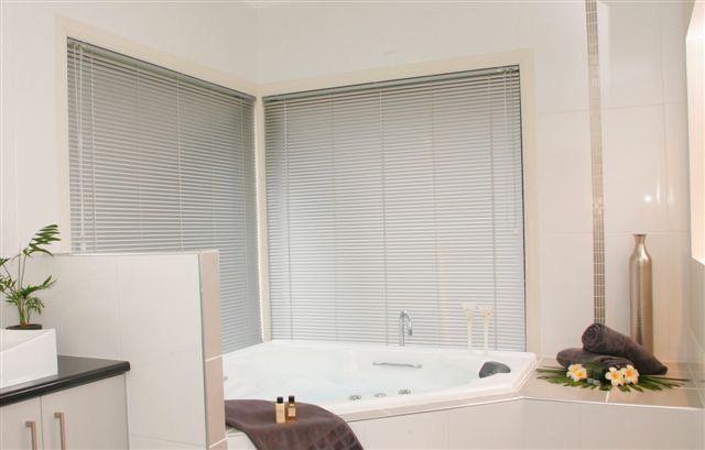 Bathroom with Venetian Blinds on the Window Behind the Bathtub — Blind Outfitters in Atherton, QLD