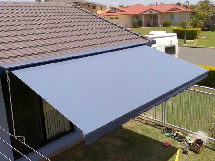 Blue Awning is Hanging From the Side of a House — Blind Outfitters in Atherton, QLD