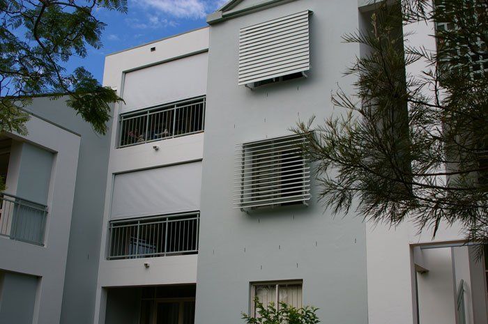 White Building With a Lot of Windows and Balconies — Blind Outfitters in Cairns Northern Beaches, QLD