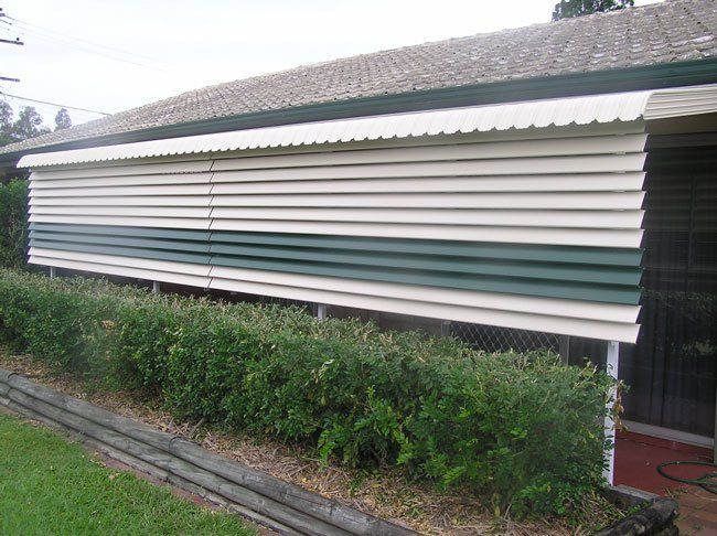House With a Green and White Awning on the Side of It — Blind Outfitters in Atherton, QLD