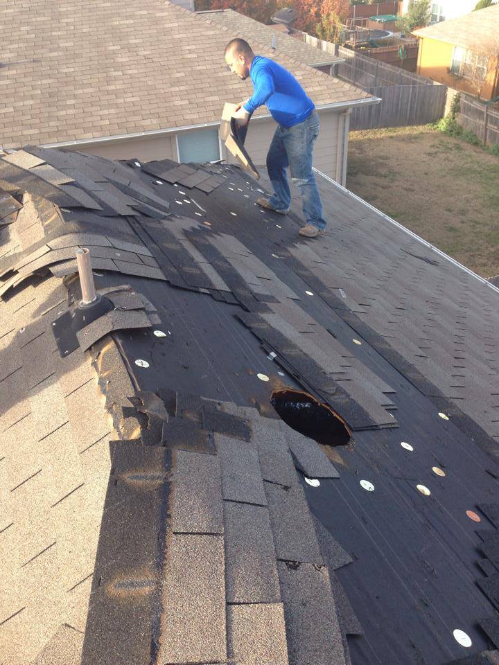 A man is working on the roof of a house