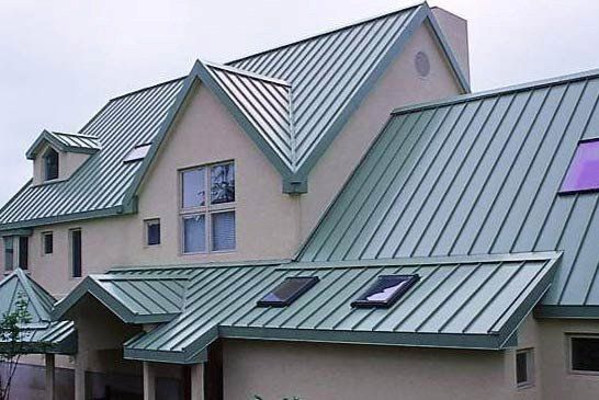 A house with a green metal roof and two skylights