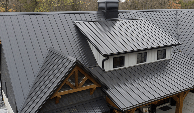 An aerial view of a house with a metal roof.