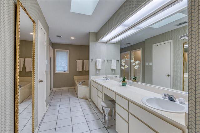 A bathroom with two sinks and a large mirror.
