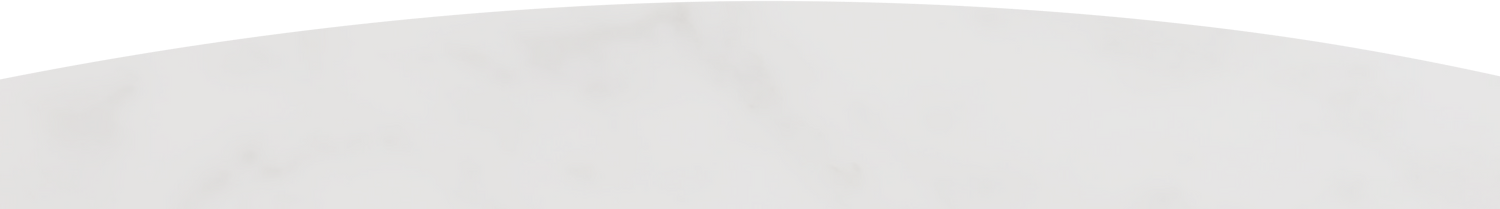 White curved object, possibly part of a structure or architectural element, against a plain background.