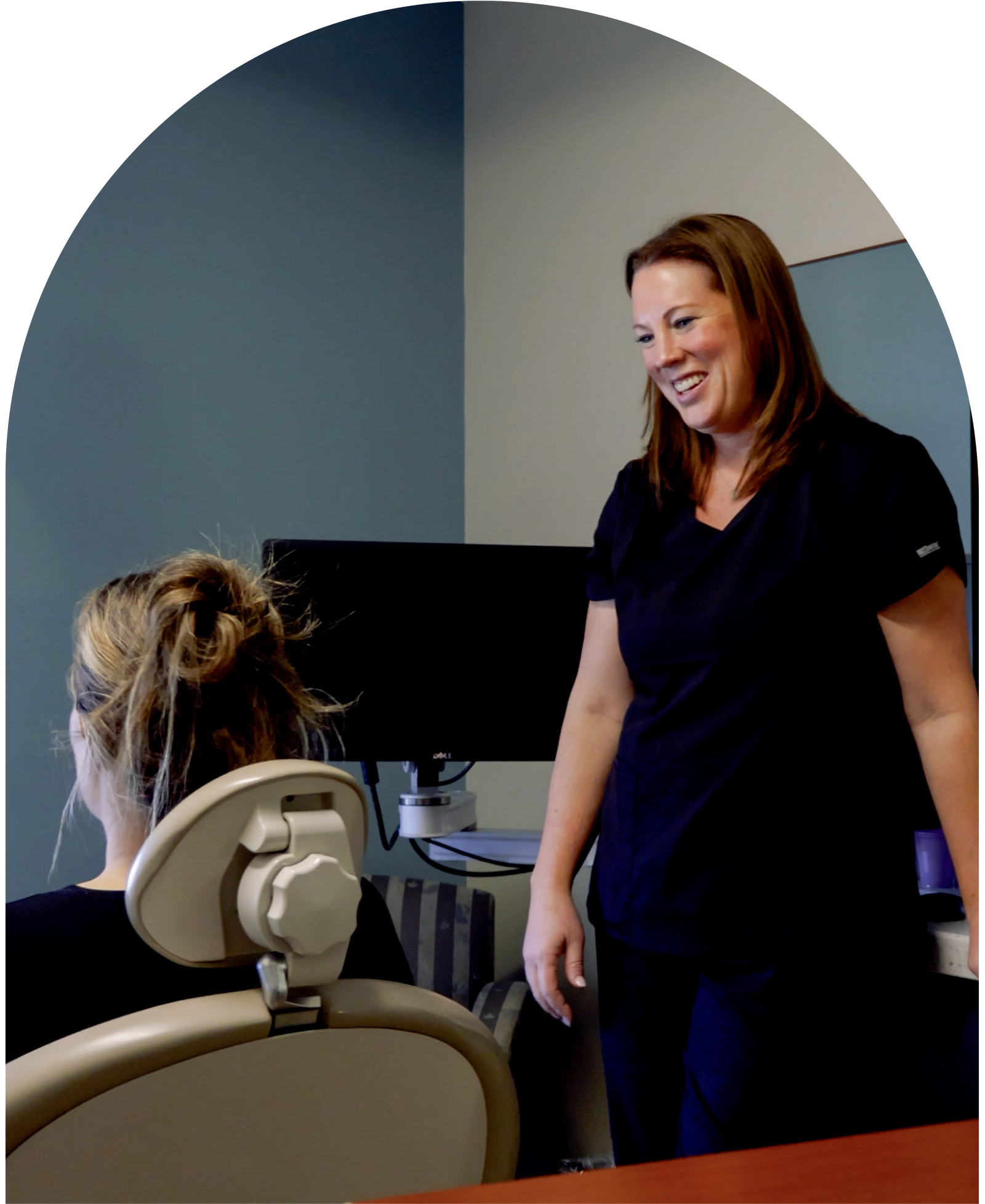 Woman in a robe looking at her face after cosmetic treatment at Vail Dental Associates in Hunt Valley, MD, 21030.