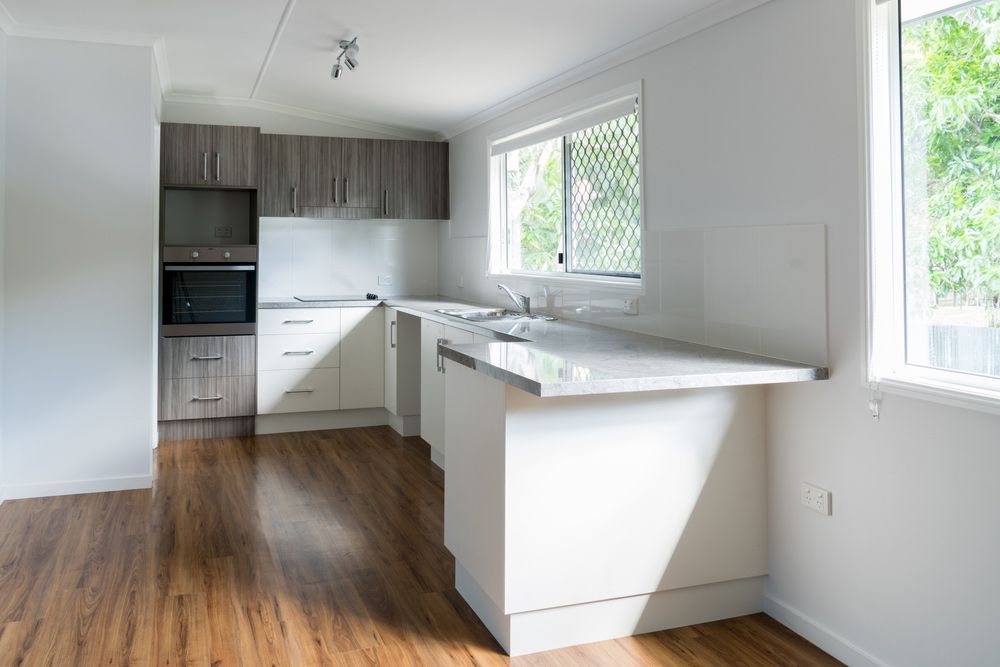 New Kitchen In Renovated House With Laminated Timber Flooring — Carl Whelan Building & Renovations In Narara, NSW