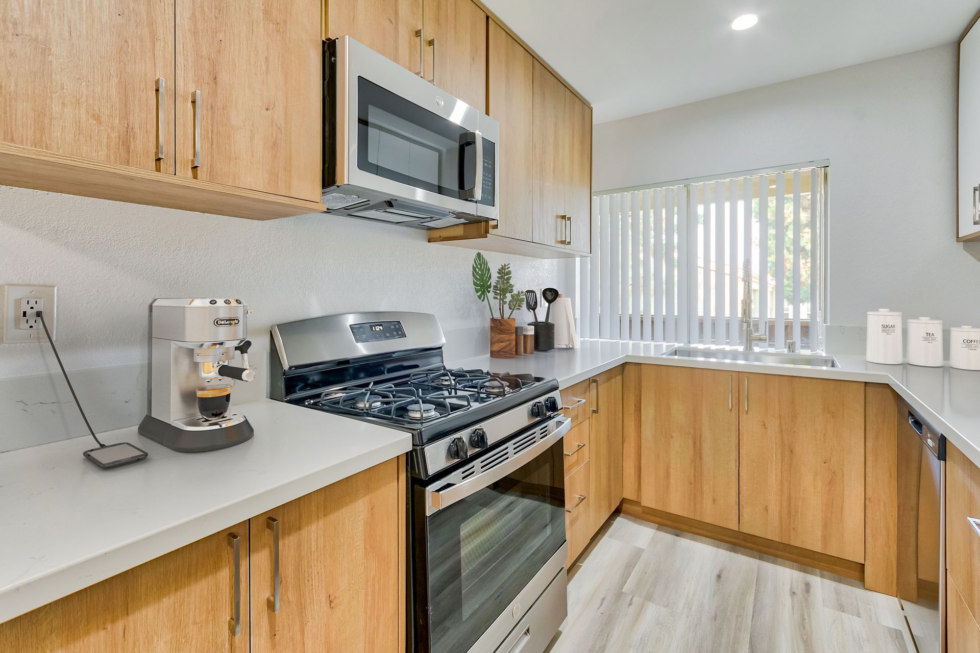 A kitchen with stainless steel appliances and wooden cabinets