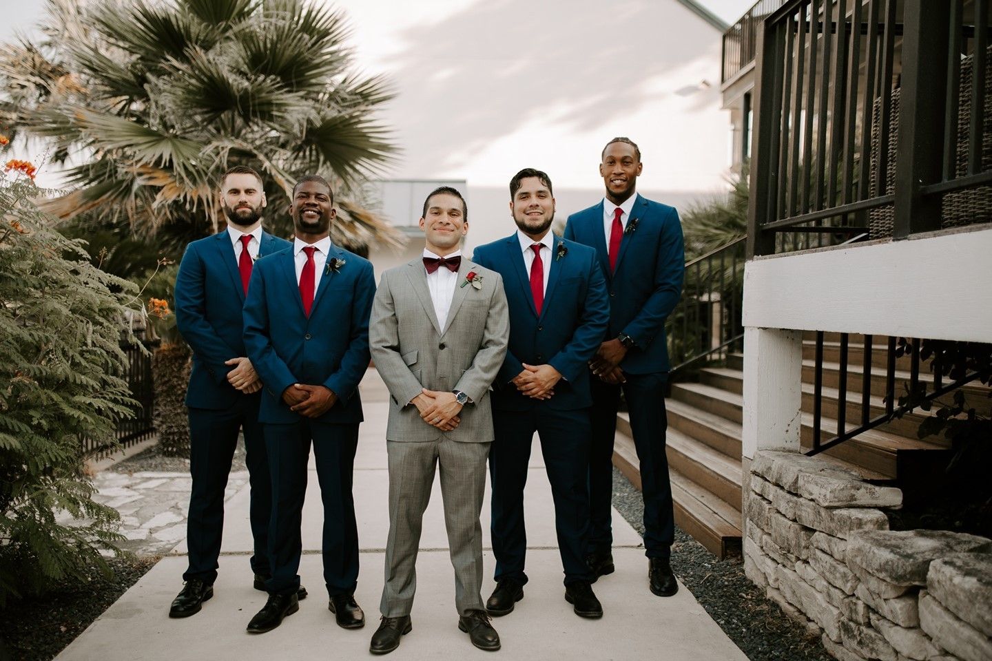 groom in grey suit groomsmen in blue suit